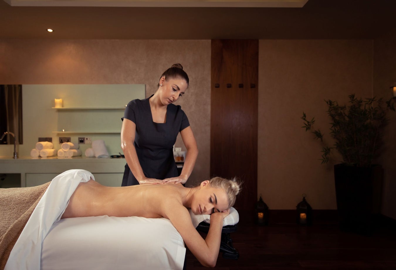 Person lying on a treatment bed being massaged
