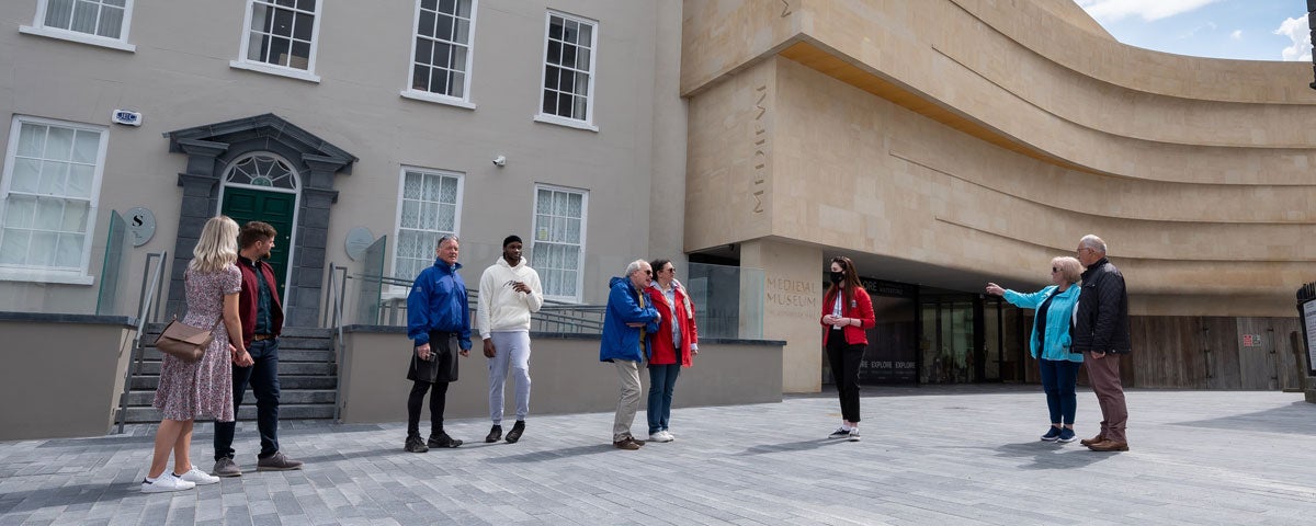 A group with a tour guide outside Waterford Treasures Museums