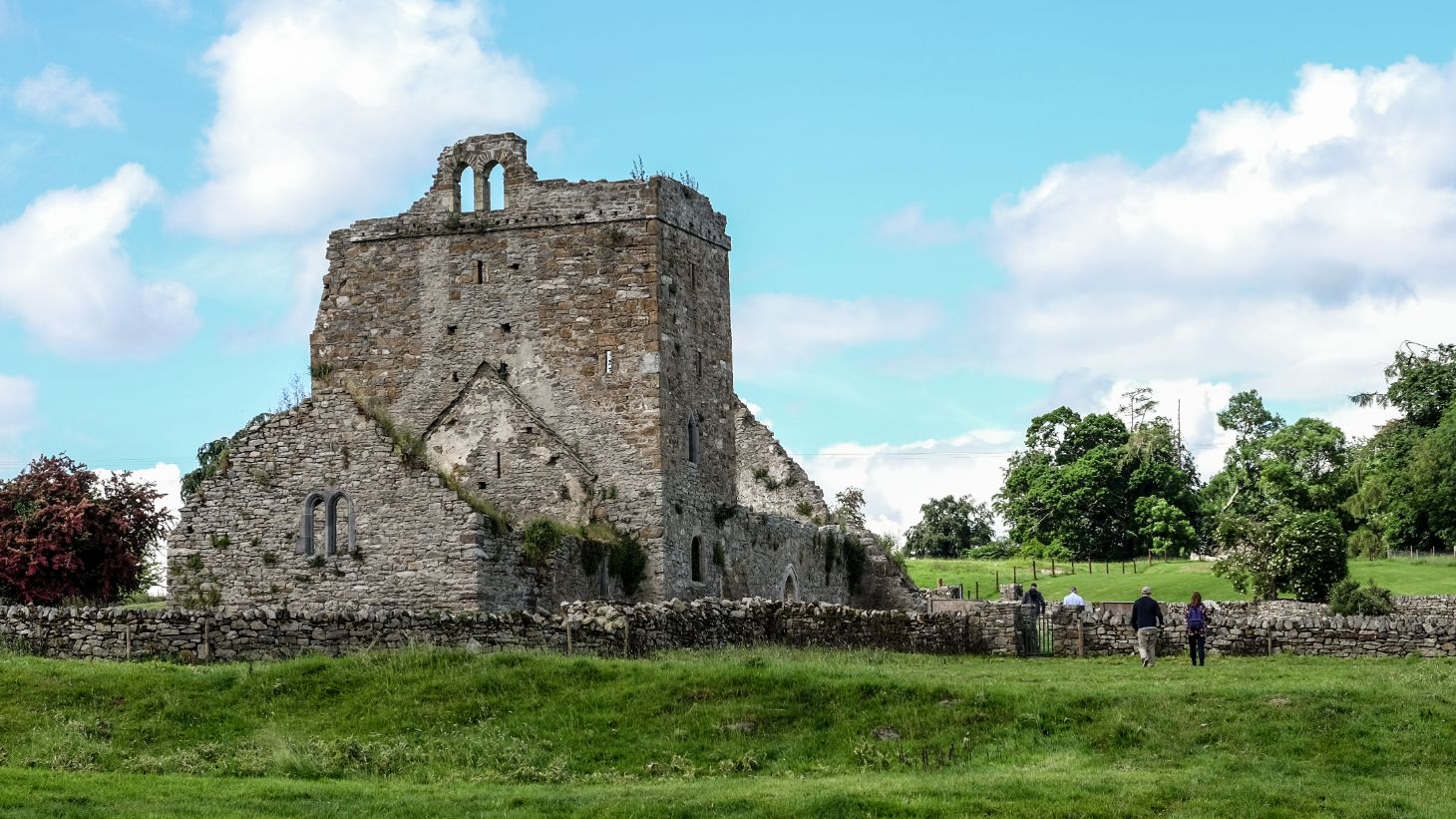 A group of people exploring the ruins at Jerpoint Park, Kilkenny