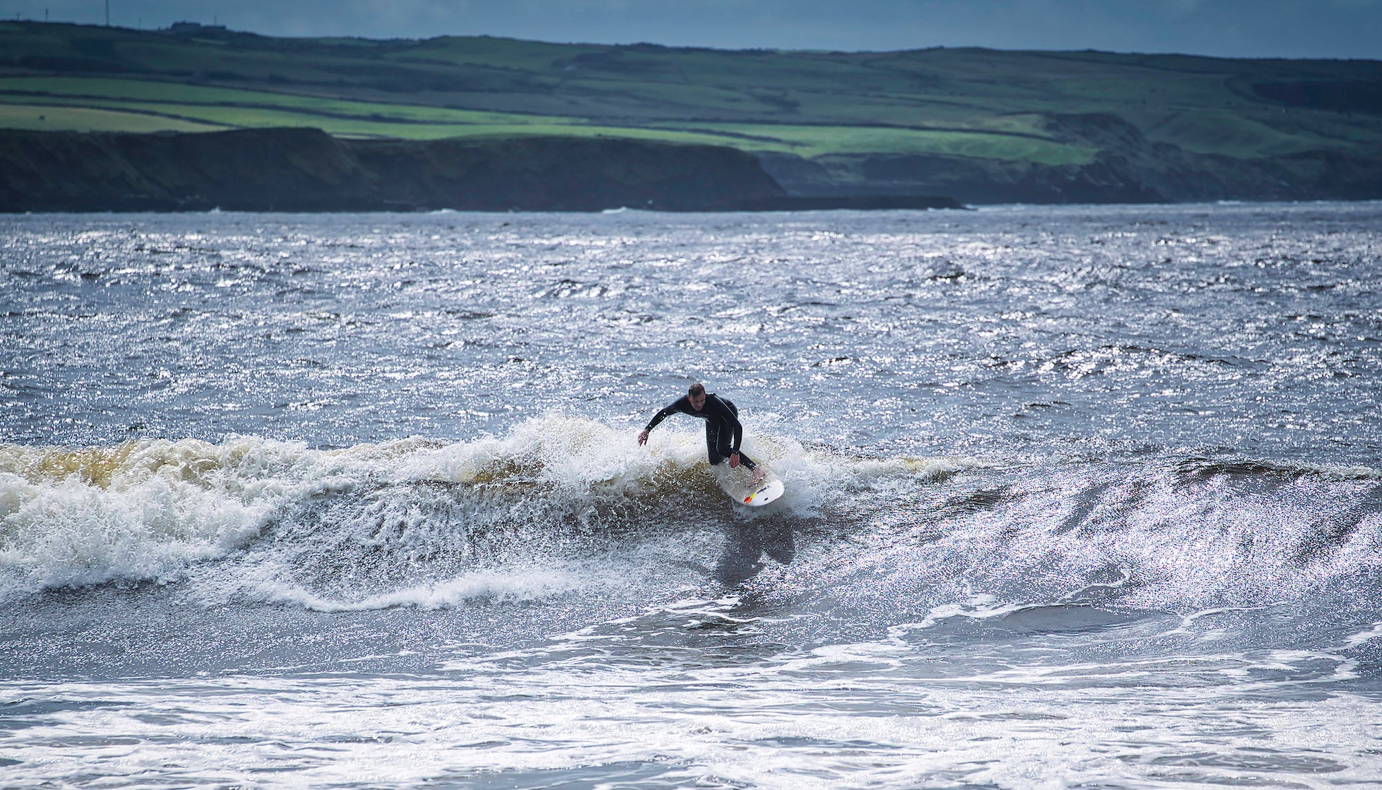 A surfer at Lahinch Beach in Co Clare
