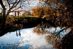 Two walkers on the banks of the Shannon Pot in autumn