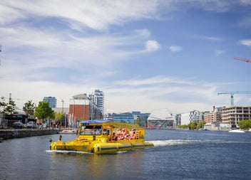 A boat with passengers on a river tour in a city