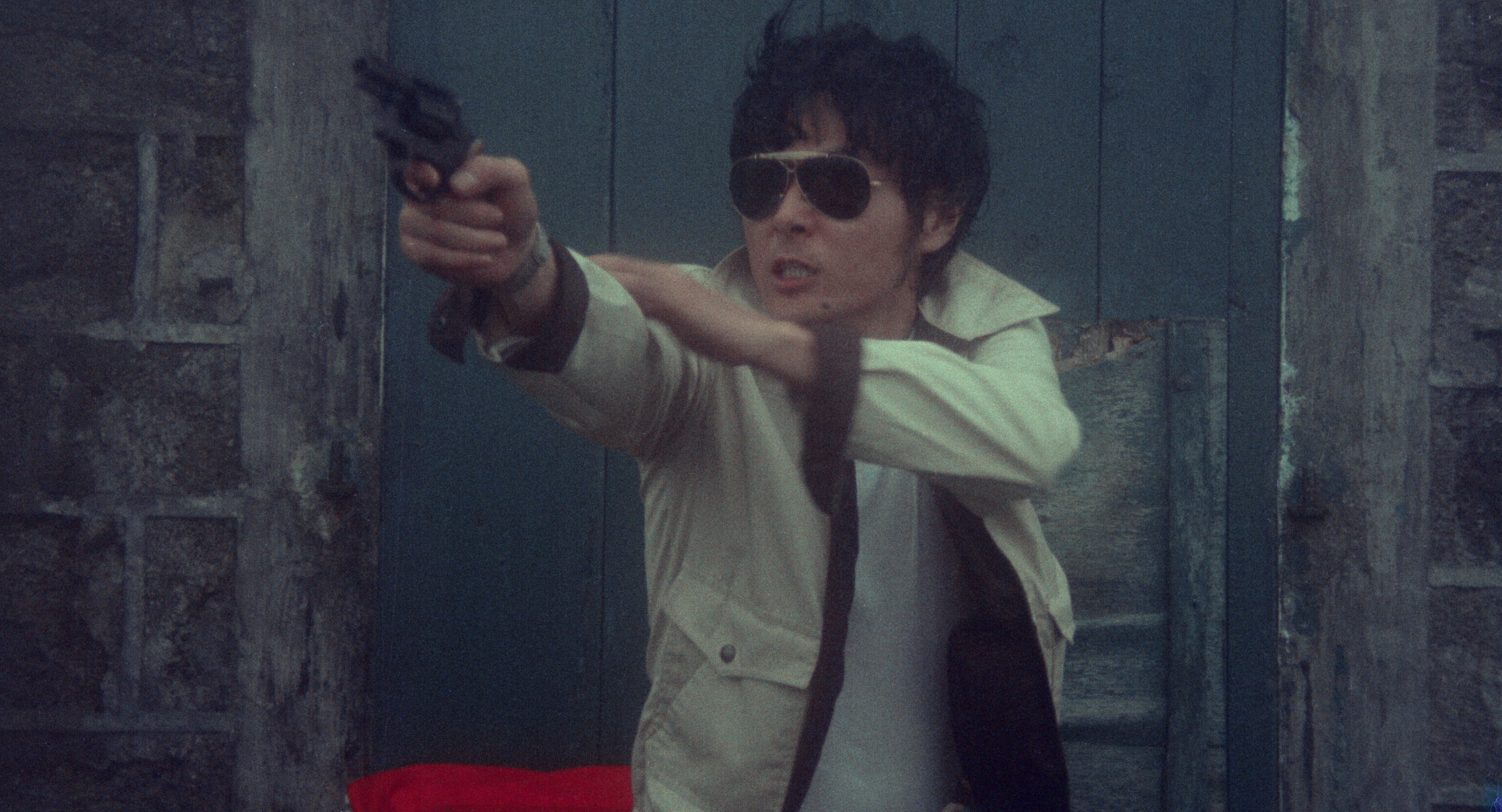 A man is pointing a pistol.