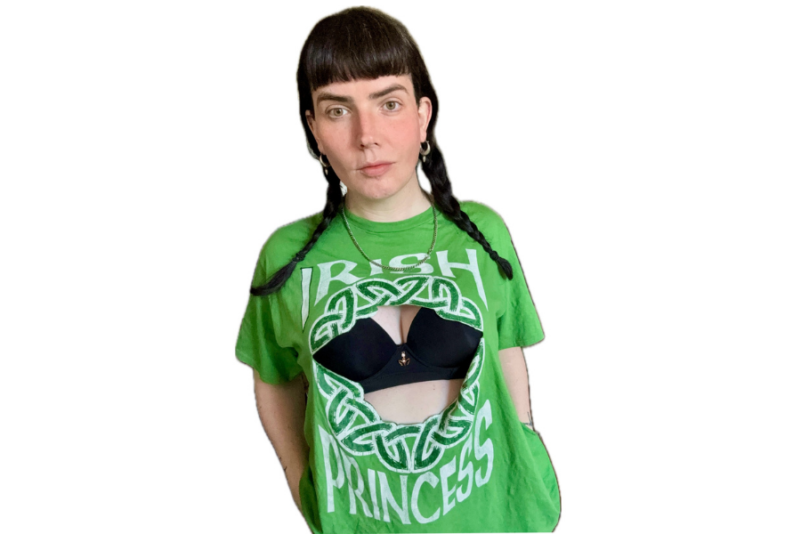 A woman wearing a green Irish theme T-shirt with front missing to show black bra underneath
