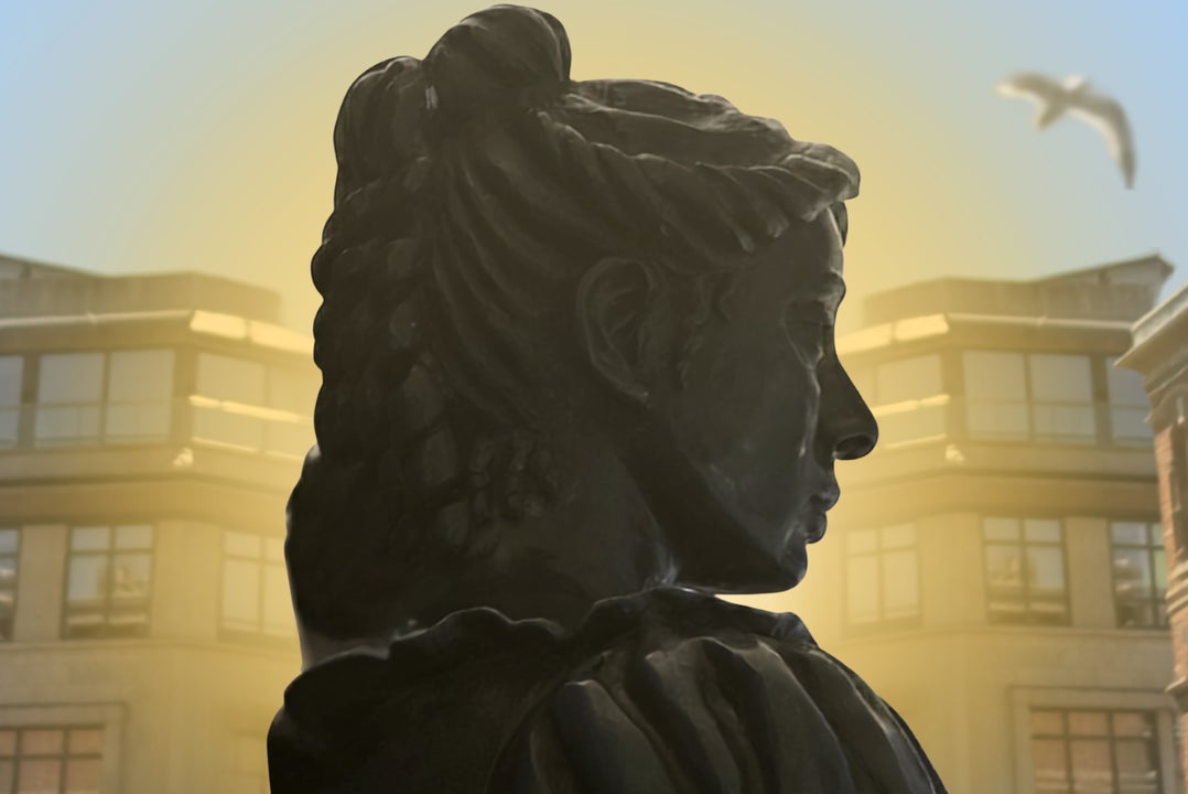 Temple Bar The Musical at Smock Alley - head and shoulders of a dark statue seen from the side with office type buildings in the background.