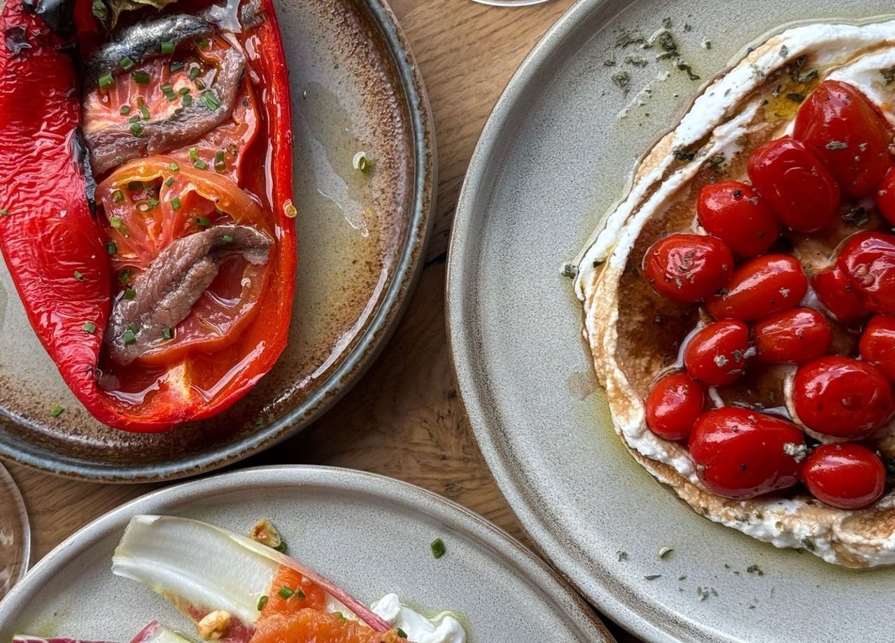 A roasted red pepper dish and a cherry tomato plate