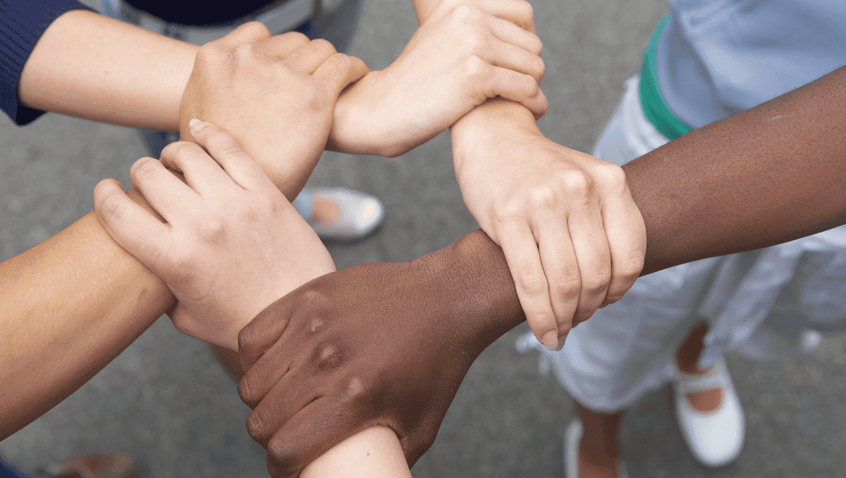 Five different skin tone arms locked together