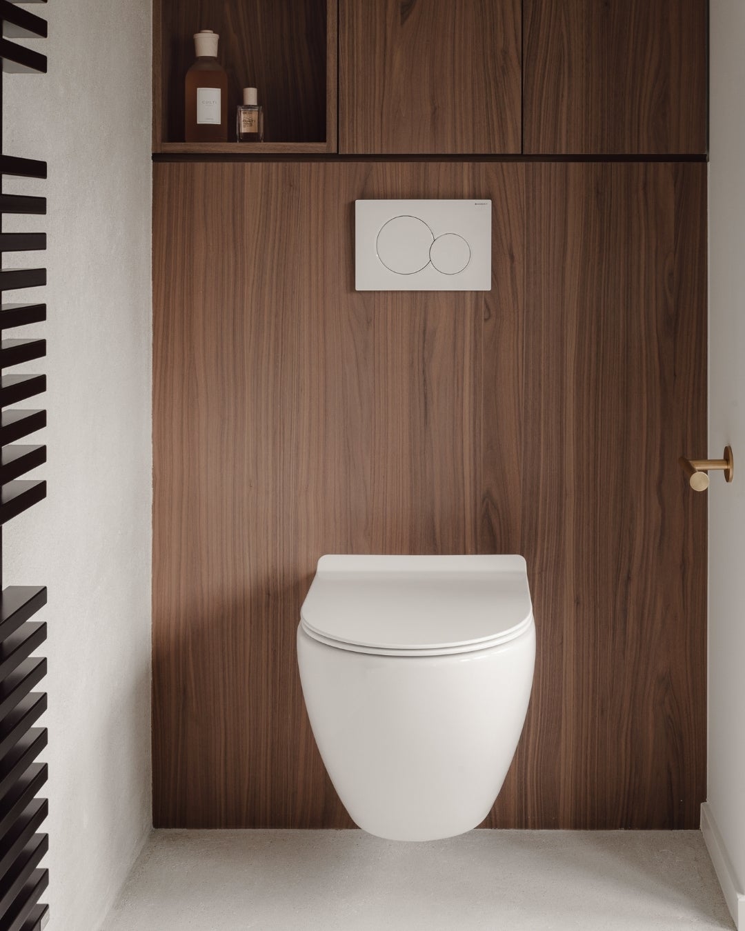 A toilet in a bathroom - wood veneer - shinnoki frozen walnut - decospan