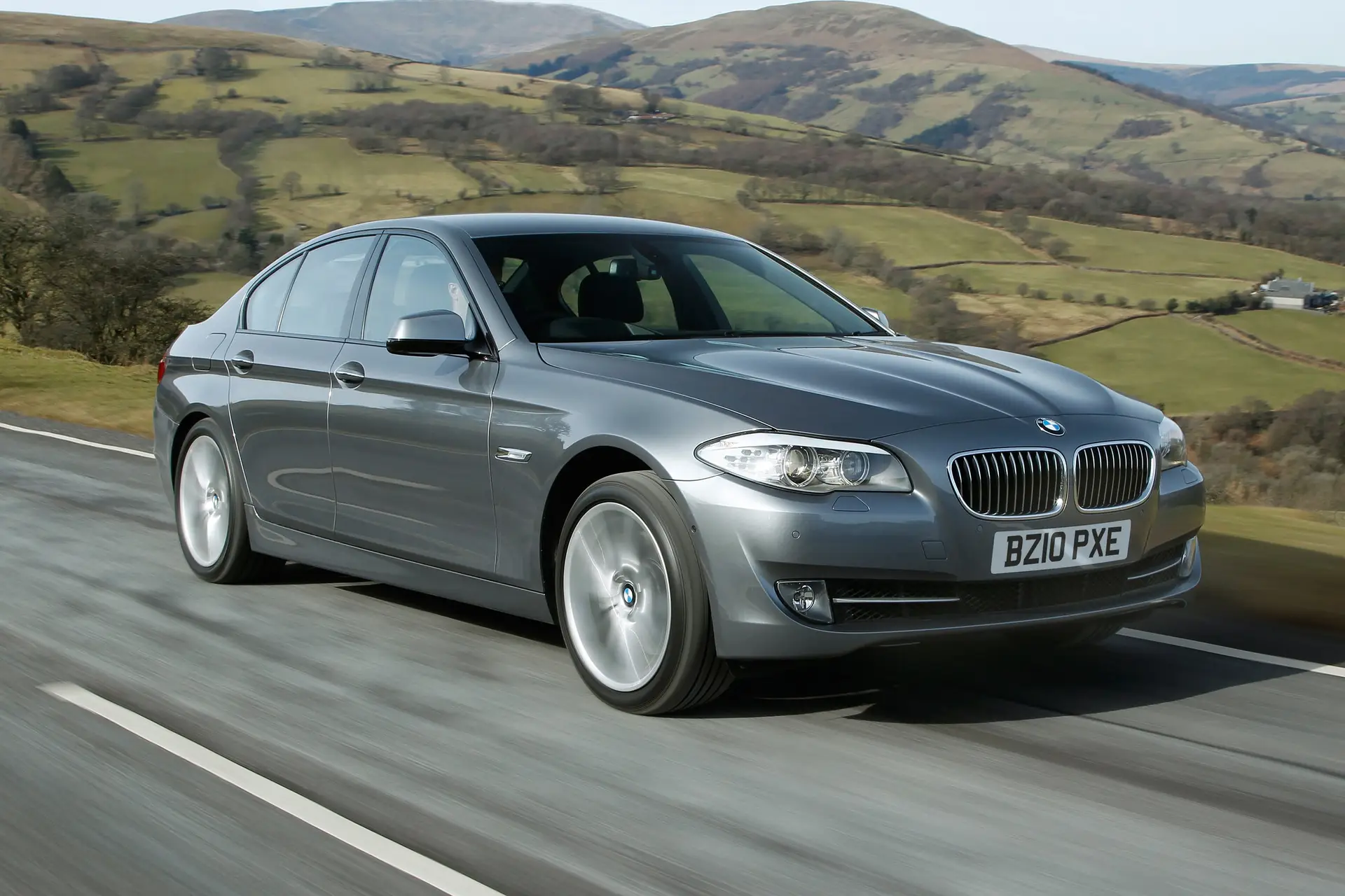 BMW 5 Series (2010-2017) Review: Exterior front three quarter photo of the BMW 5 Series on the road