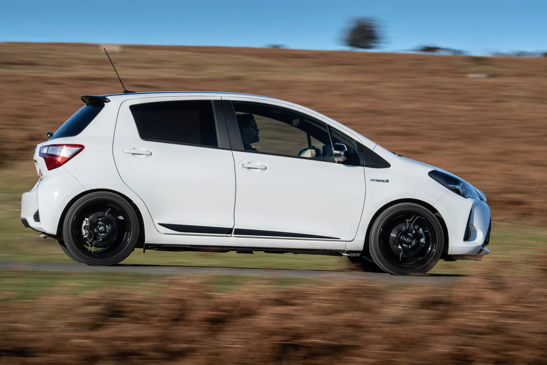 Toyota Yaris (2011-2020) Review: exterior side photo of the Toyota Yaris on the road