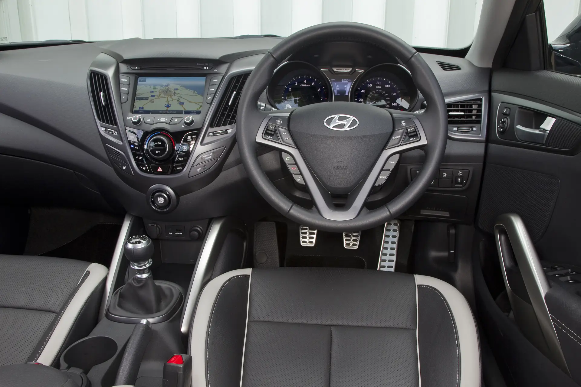 Hyundai Veloster (2013-2015) Review: interior close up photo of the Hyundai Veloster dashboard