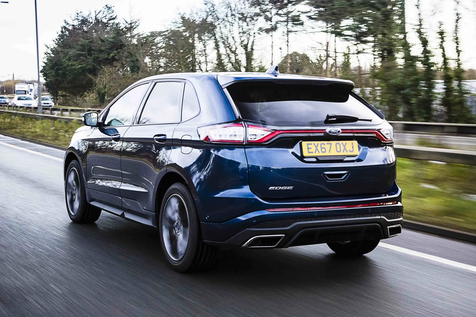 Ford Edge (2016-2019) Review: exterior rear three quarter photo of the Ford Edge on the road
