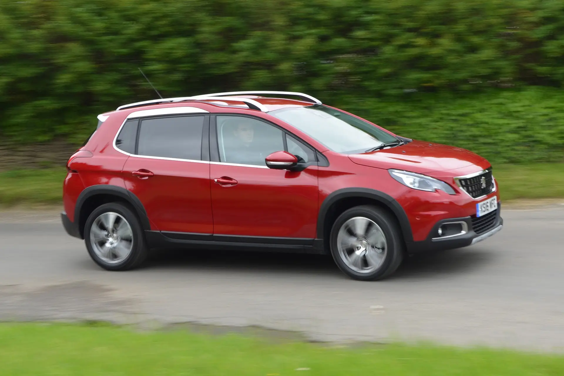 Peugeot 2008 (2013-2019) Review: exterior side photo of the Peugeot 2008 on the road