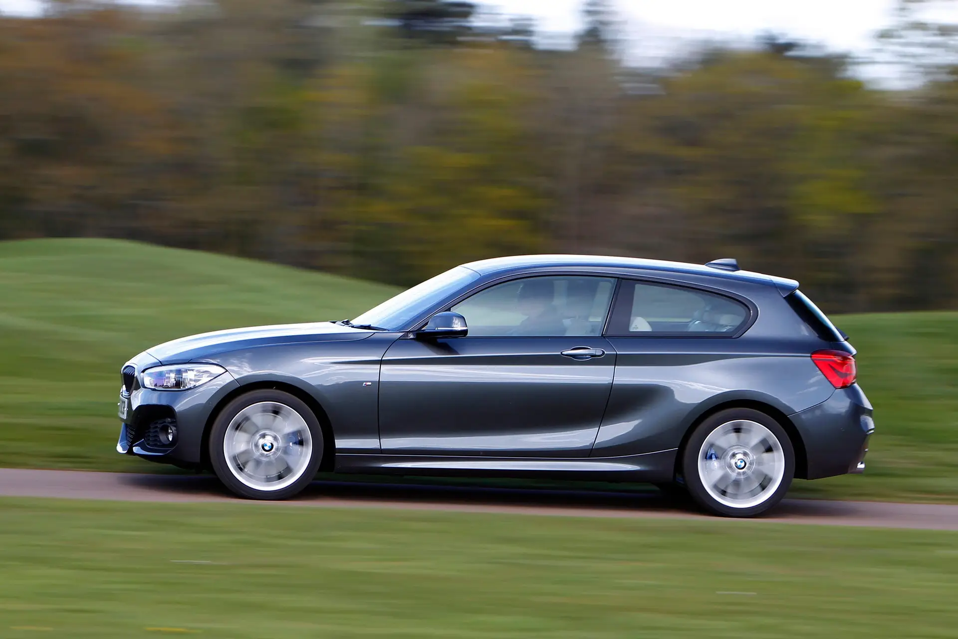 BMW 1 Series (2011-2019) Review: exterior side photo of the BMW 1 Series on the road