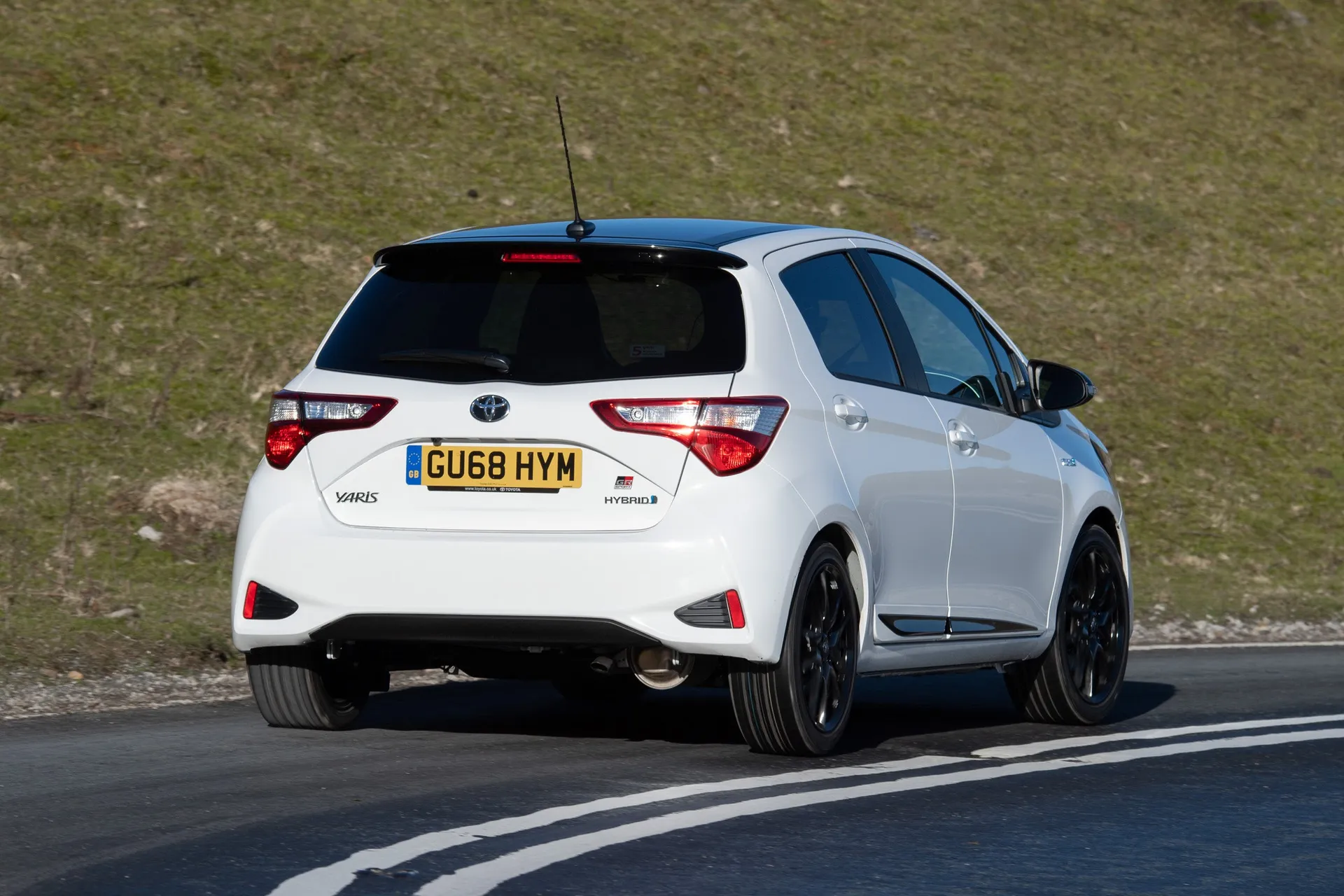 Toyota Yaris (2011-2020) Review: exterior rear three quarter photo of the Toyota Yaris on the road