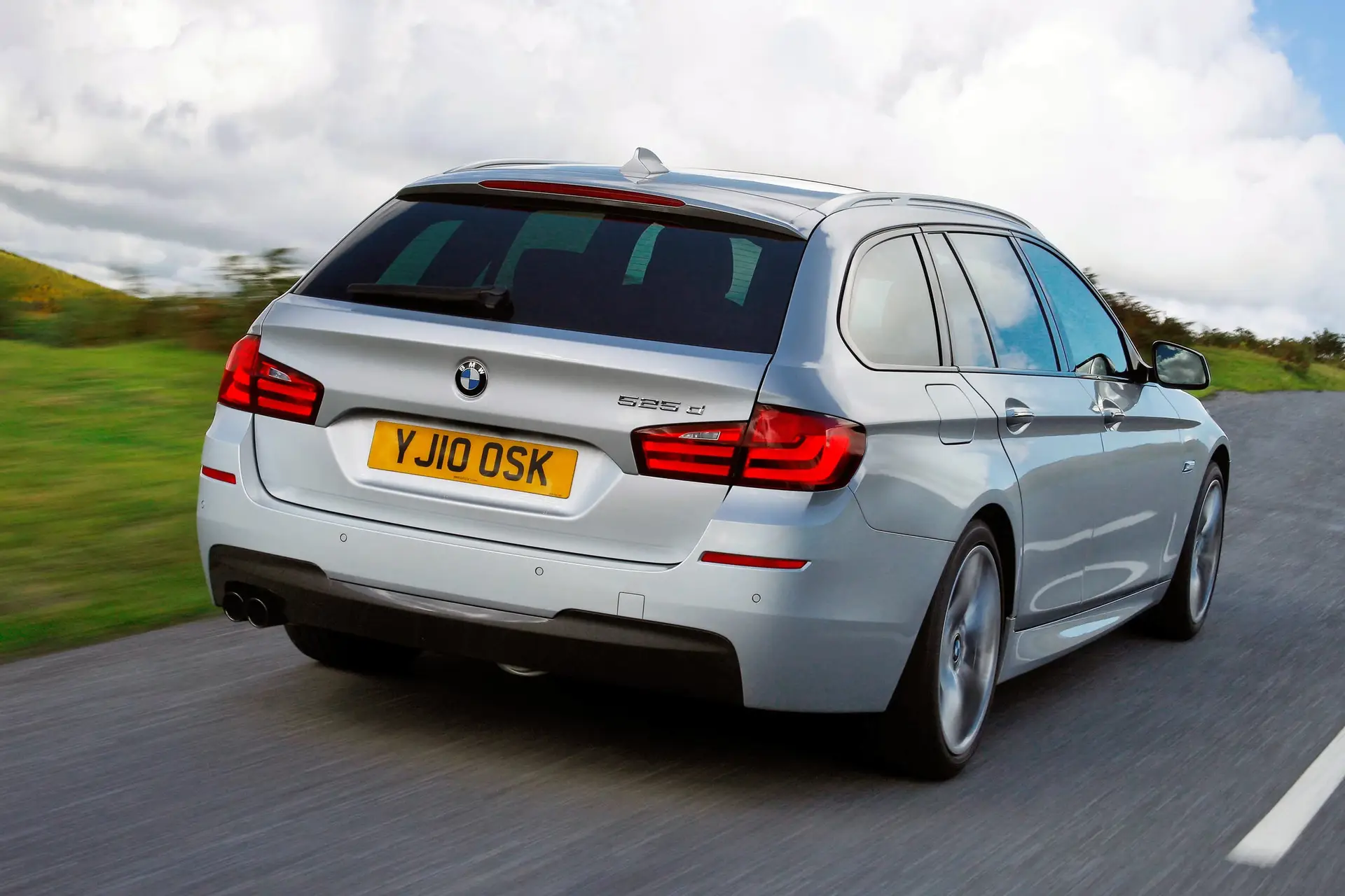 BMW 5 Series Touring (2010-2017) Review: Exterior rear three quarter photo of the BMW 5 Series Touring on the road
