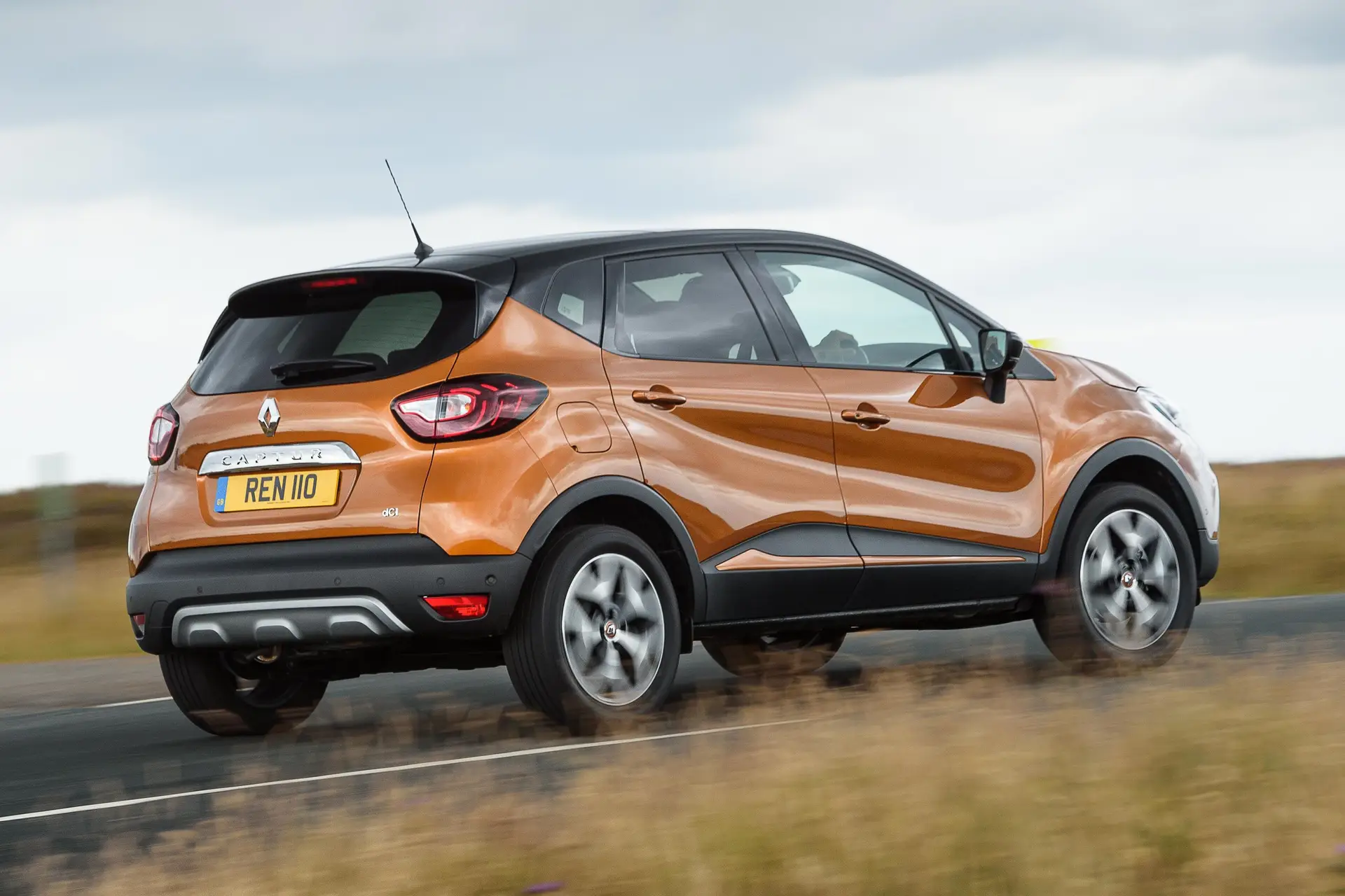 Renault Captur (2013-2019) Review: exterior rear three quarter photo of the Renault Captur on the road