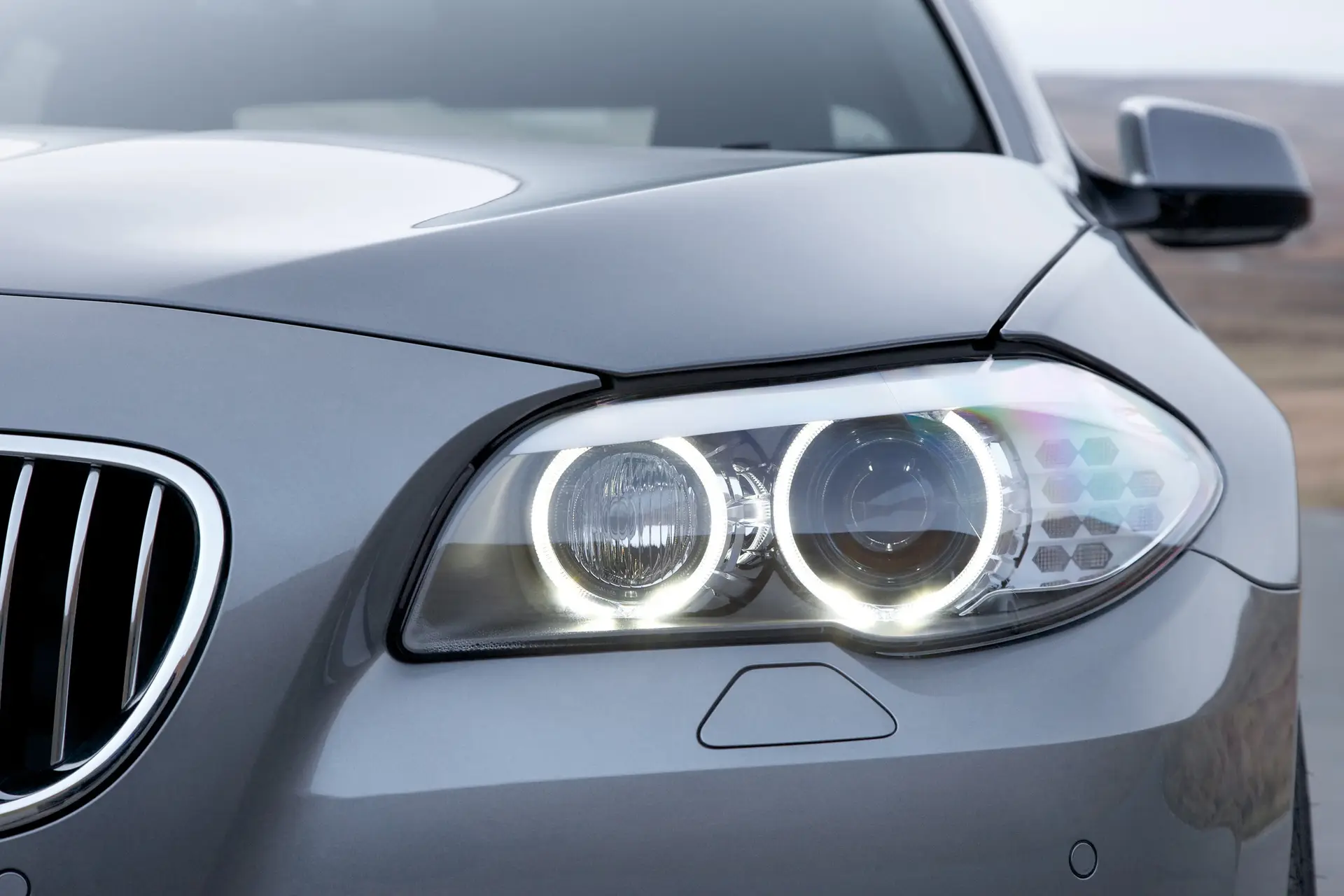 BMW 5 Series (2010-2017) Review: Exterior close up photo of the BMW 5 Series headlight