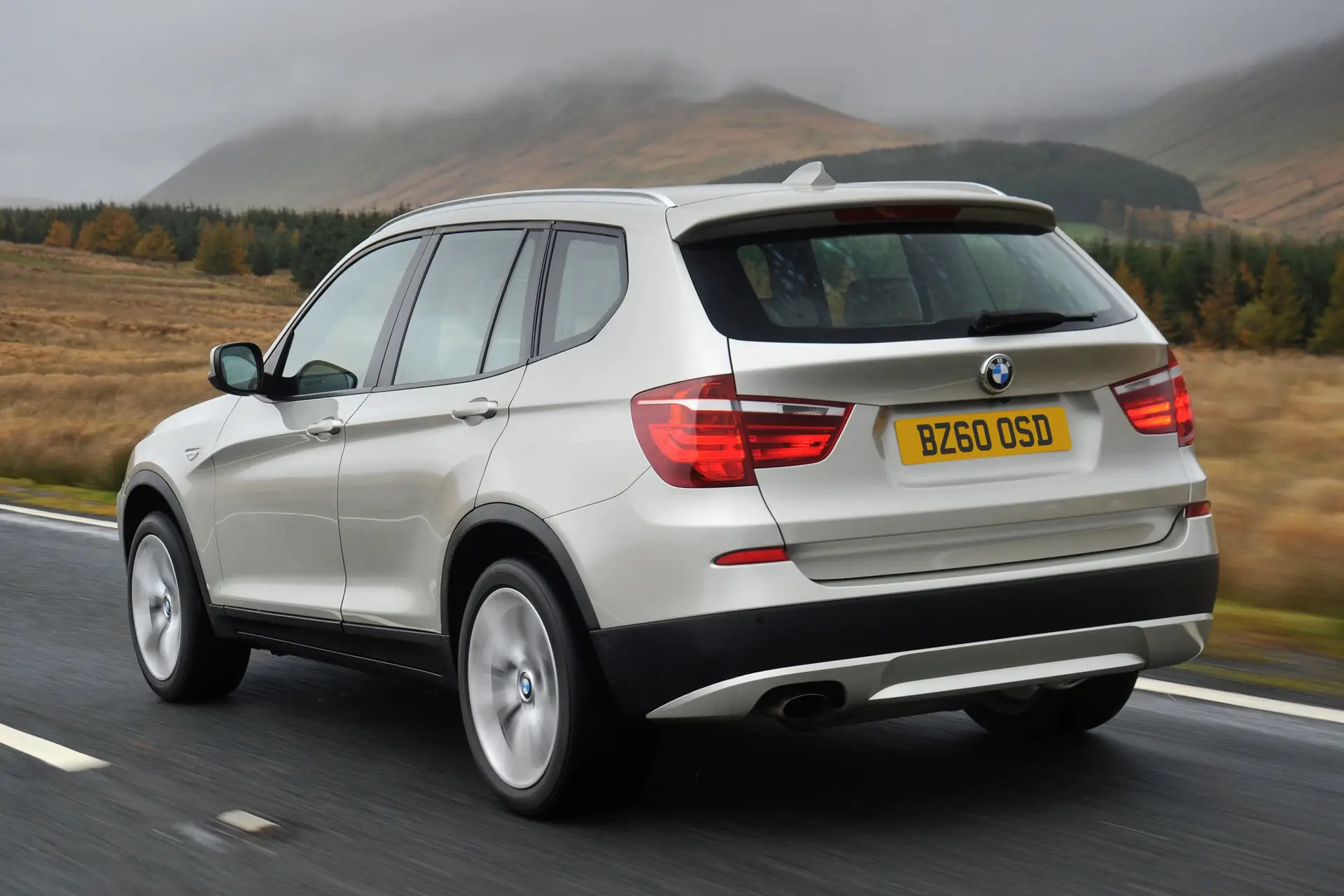 BMW X3 (2010-2018) Review: Exterior rear three quarter photo of the BMW X3 on the road