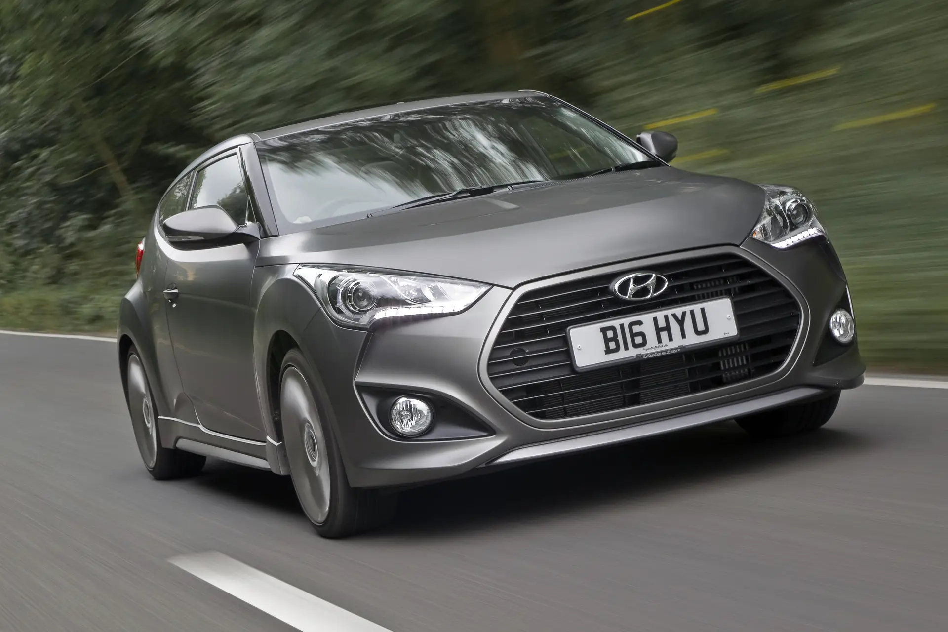 Hyundai Veloster (2013-2015) Review: exterior front three quarter photo of the Hyundai Veloster on the road
