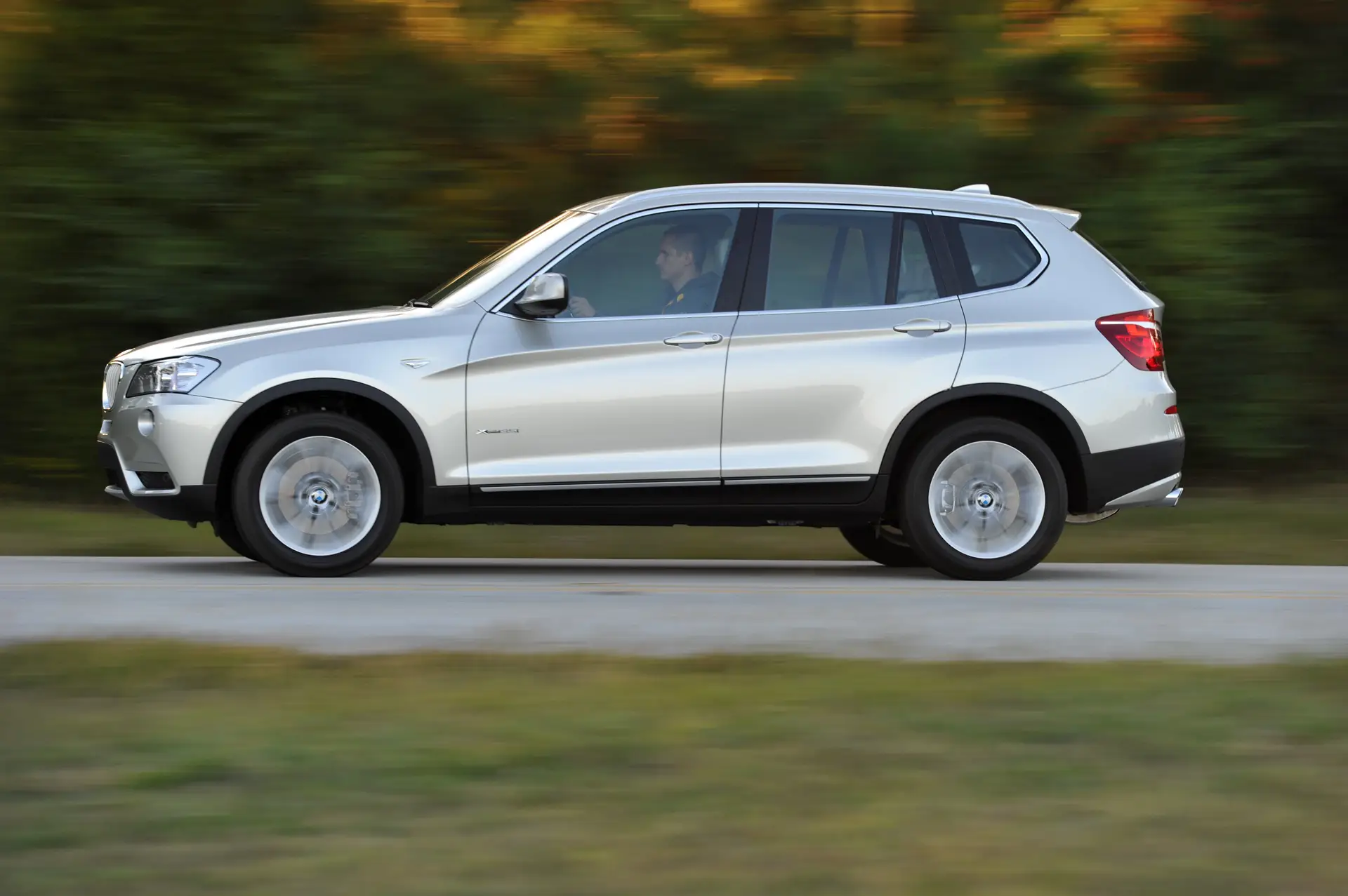 BMW X3 (2010-2018) Review: Exterior side photo of the BMW X3 on the road
