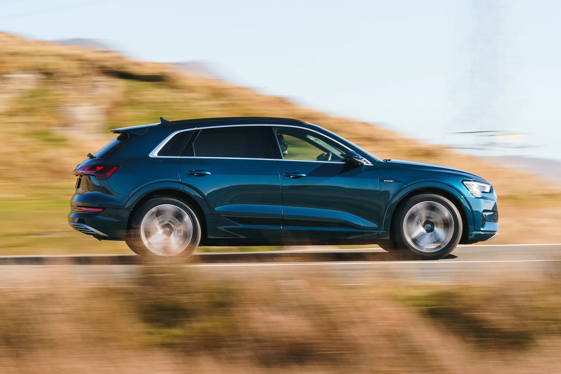 Audi e-tron (2019-2022) Review: exterior side photo of the Audi e tron on the road
