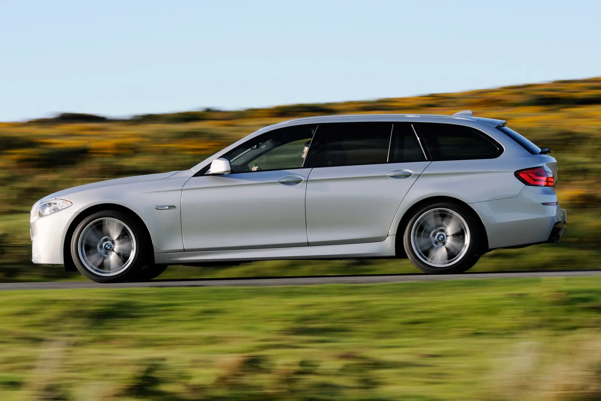 BMW 5 Series Touring (2010-2017) Review: Exterior side photo of the BMW 5 Series Touring on the road