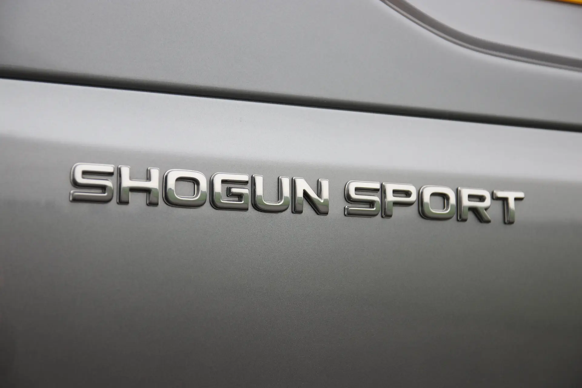 Mitsubishi Shogun Sport (2018-2021) Review: exterior close up photo of the Mitsubishi Shogun Sport badge