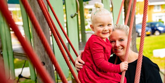 A child and her mother in the playground.