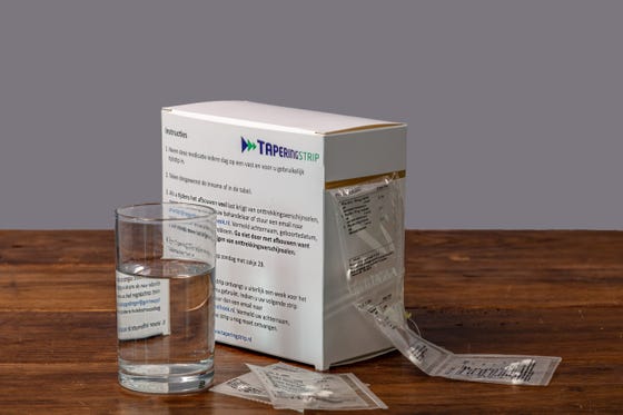 Tapering strip on a table with a glass of water.