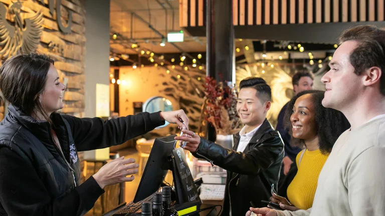 A man handing a card to a group of people