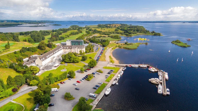 A aerial view of a body of water with a parking lot and boats