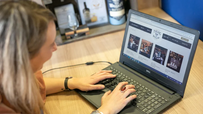 A woman typing on a laptop