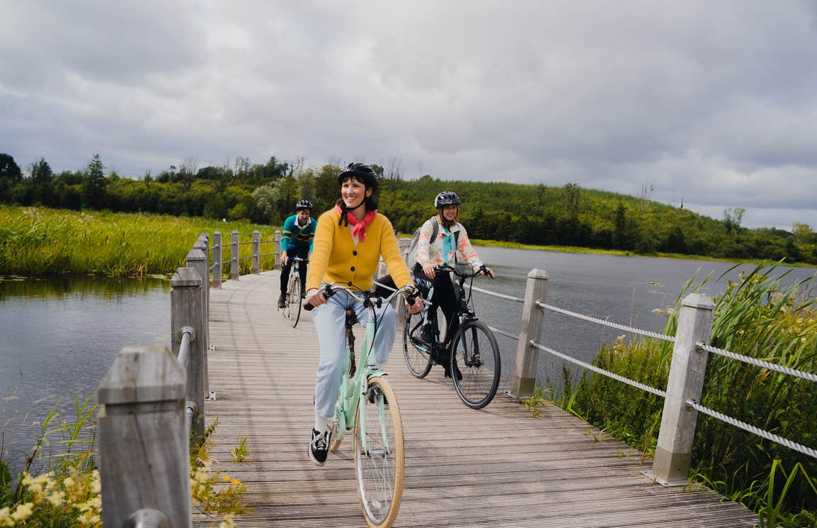 People cycling the Acres Lake Floating Boardwalk in Co Leitrim