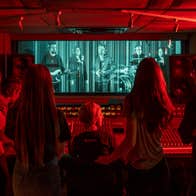 Group of visitors experiencing the Virtual Band in Studios