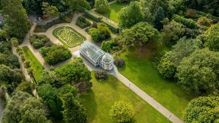Aerial view of a well maintained garden and glasshouse
