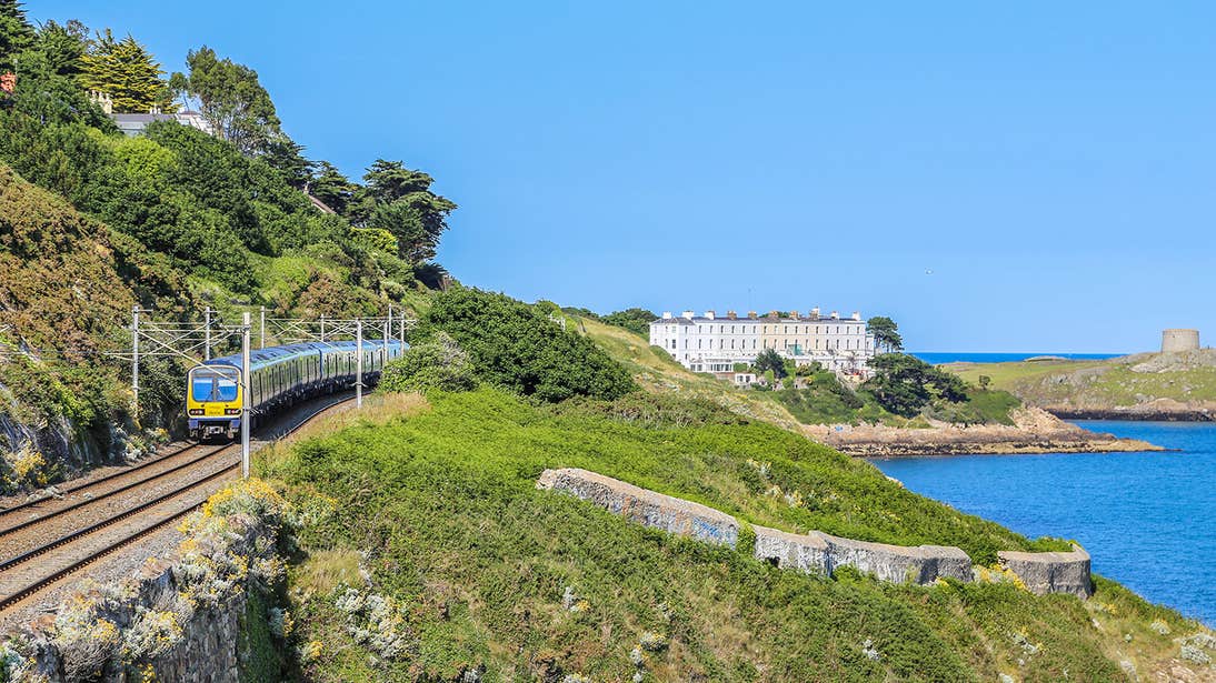 The Dart train going by the sea in Killiney in Dublin