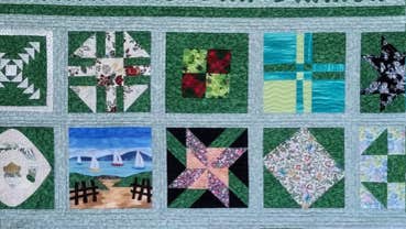Exhibition: Thread Therapy, Irish Patchwork Society North Eastern Branch, a patchwork quilt mostly in shades of blue and green.