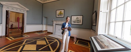 A woman standing in a large room in Casino Marino