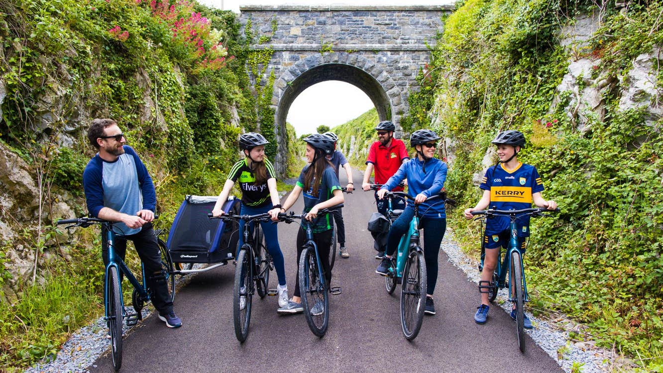 A group of cyclists stopped on a path talking to each other