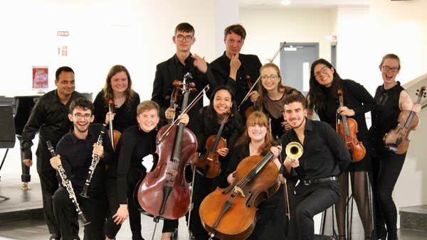Muicians smiling with their instruments