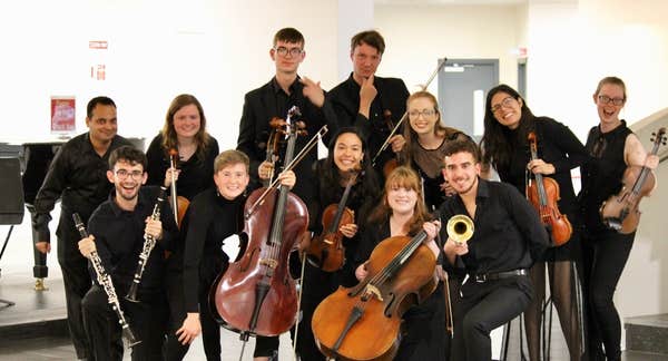 Muicians smiling with their instruments