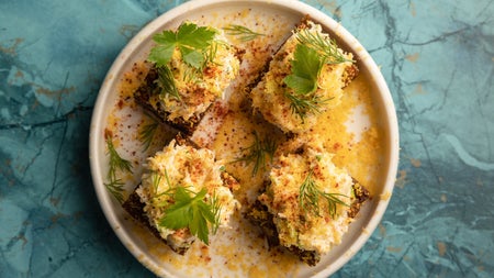 Food on a white plate with a blue backdrop