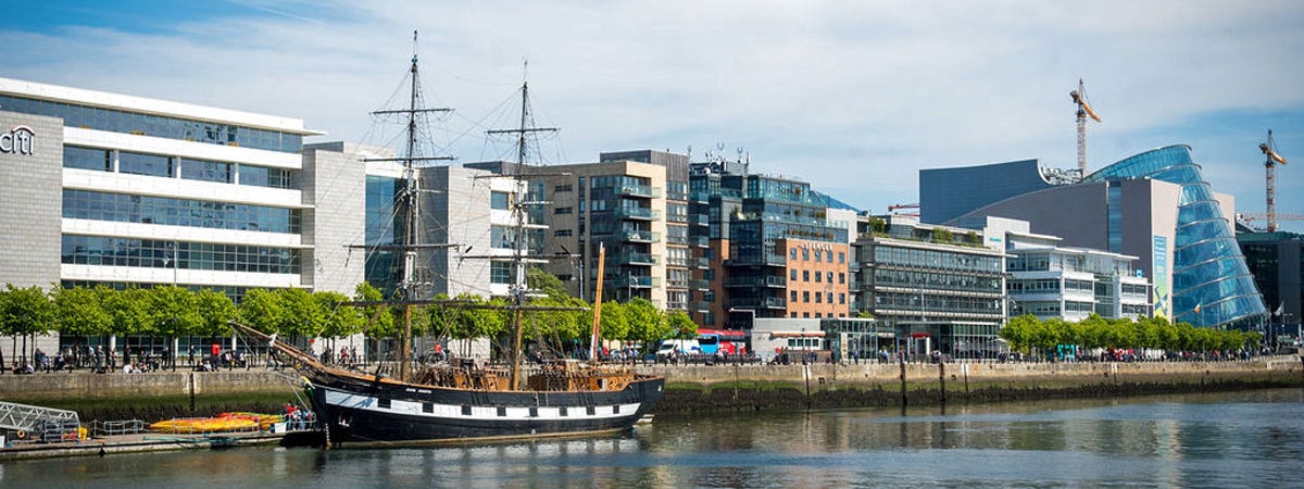 A view of the Jeanie Johnston docked on the Custom House Quay in Dublin's Docklands with a view of the Convention Centre in the background