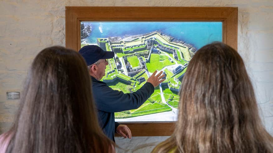 Two people getting a tour of Charles Fort in Kinsale