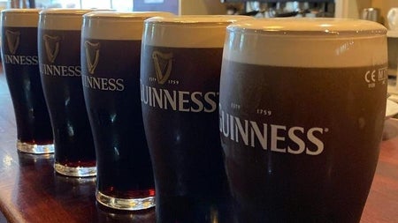 Five pints of Guinness lined up on the bar at The Patriot's Inn