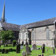 A large church with a cemetery and lots of headstones