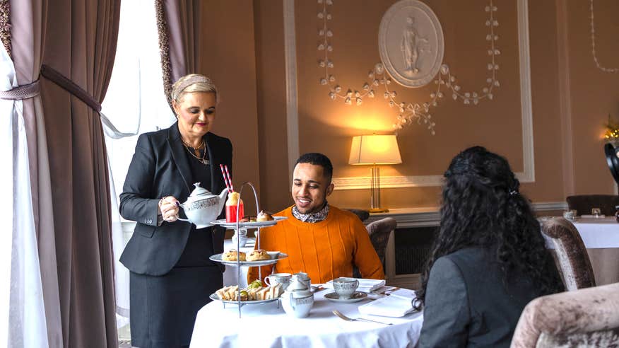 A couple being served afternoon tea at Mount Juliet Estate in County Kilkenny