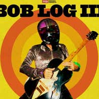 Bog Lob III poster in yellow with a man playing an electric guitar wearing a silver shirt and motorcycle helmet with black visor.