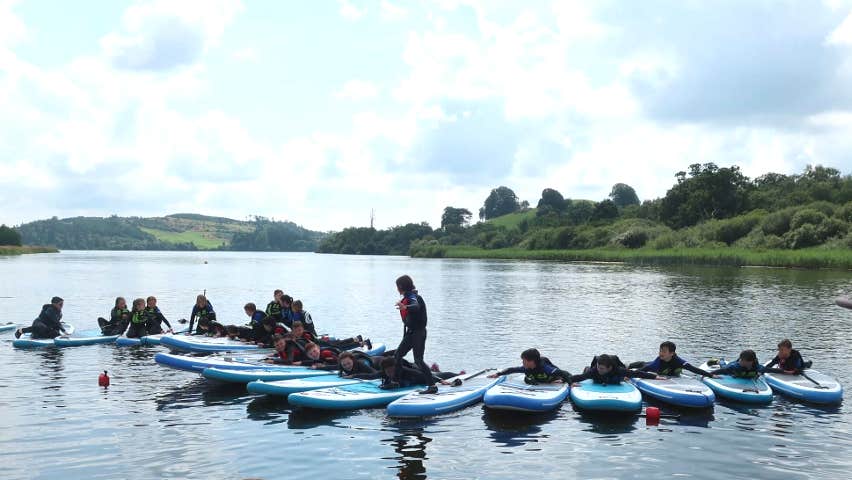 Paddlebaords lined up on the lake
